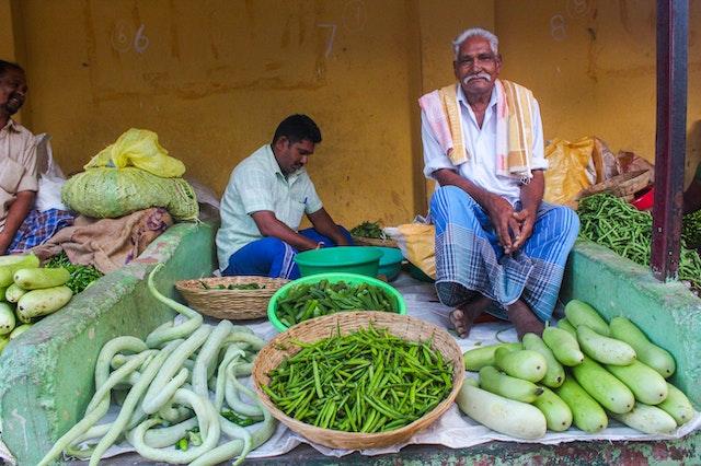 Man selling is locally grown vegetables.